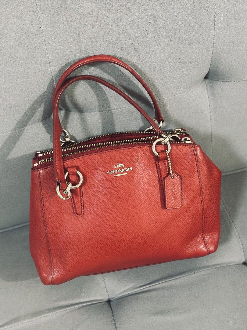 Coach Red Leather Satchel HandbIag (Category: Luxury Bags & Wallets) located in Tarlac. Submitted by via_banana (Listing ID 1468096506, Image 1). Description: - Brand: Coach - Material: Premium red pebbled leather - Hardware: Gold-tone throughout with hanging logo charm - Handles: Double rolled top handles - Closure: Secure zip-top closure - Interior: Fabric-lined with multiple compartments - Condition: Clean structure, well-maintained grain text