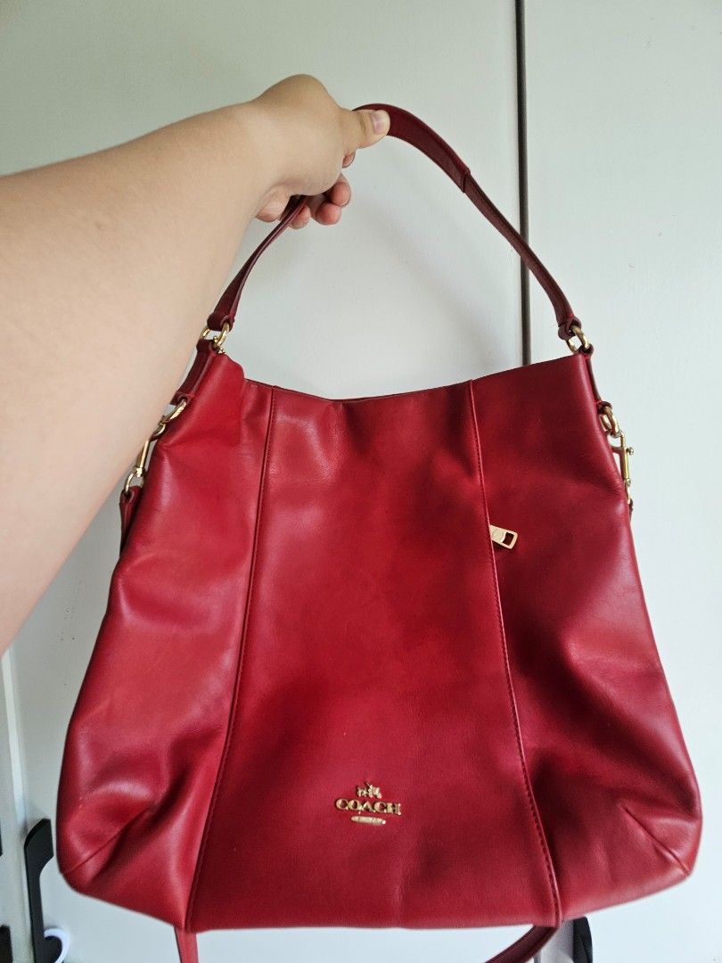 Coach Red Leather Shoulder Bag (Category: Shoulder Bags) located in Manila. Submitted by butterplush.collection (Listing ID 1468101170, Image 1). Description: - Brand: Coach with dustbag - Material: Soft red leather - Hardware: Gold-tone detailing - Pockets: Convenient front zipper pocket - Straps: Double shoulder straps with metal rings - Interior: Spacious main compartment for daily essentials - Condition: with slight scuffs and never been used