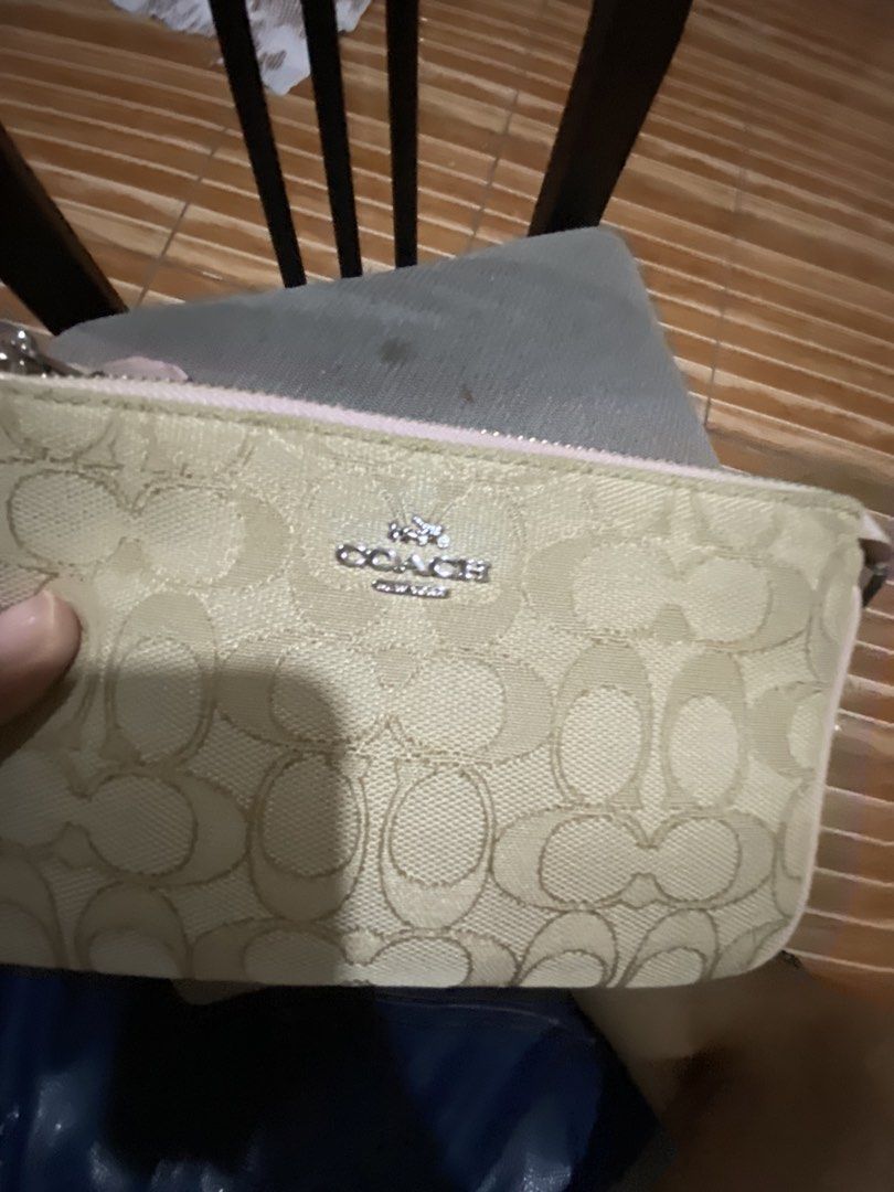 Coach Wristlet Canvas (Category: Luxury Bags & Wallets) located in Caloocan City. Submitted by elianique (Listing ID 1468072131, Image 2). Description: - Brand: Coach - Design: Signature monogram canvas in beige with pink leather trim and silver-tone hardware - Strap: Includes detachable metal chain strap for versatile styling - Interior: Pink fabric lining with convenient slip pockets - Closure: Secure top zip closure with signature Coach hangta