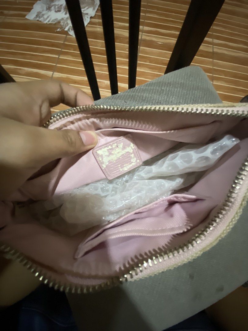Coach Wristlet Canvas (Category: Luxury Bags & Wallets) located in Caloocan City. Submitted by elianique (Listing ID 1468072131, Image 3). Description: - Brand: Coach - Design: Signature monogram canvas in beige with pink leather trim and silver-tone hardware - Strap: Includes detachable metal chain strap for versatile styling - Interior: Pink fabric lining with convenient slip pockets - Closure: Secure top zip closure with signature Coach hangta