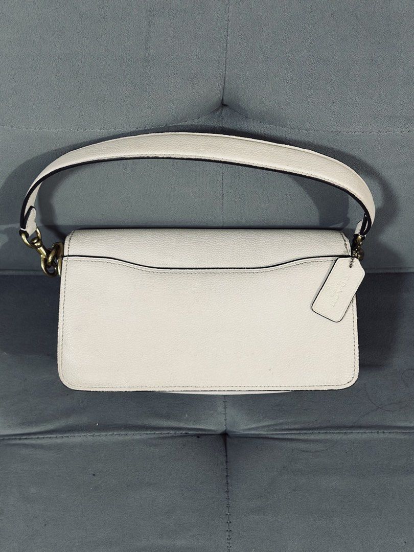 Coach Tabby Shoulder Bag White Leather (Category: Luxury Bags & Wallets) located in Tarlac. Submitted by via_banana (Listing ID 1468198586, Image 2). Description: - Brand: Coach - Material: White pebbled leather with tan suede lining - Hardware: Brass C hardware - Handle: Single detachable handle with Coach hangtag - Compartments: Center zip compartment, interior slip pocket, and back exterior slip pocket - Condition: Clean interior and exterior,