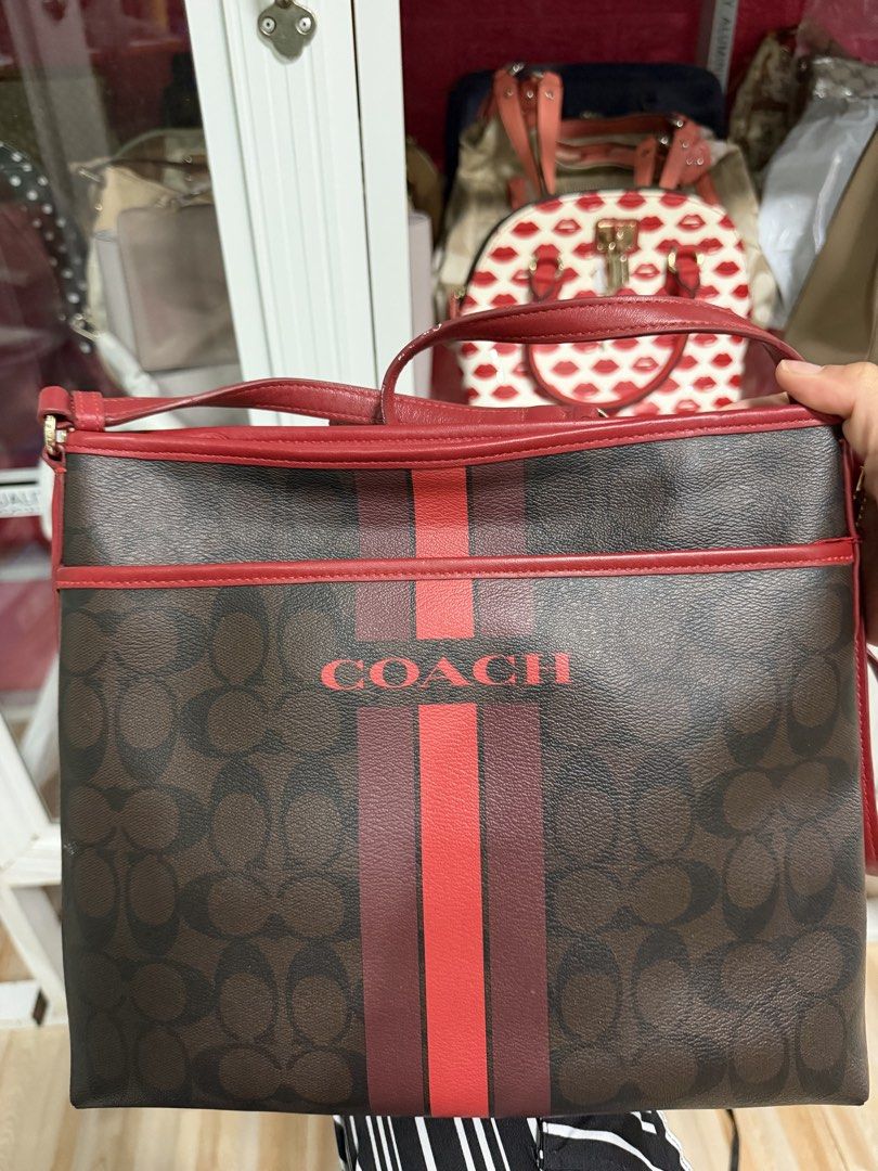 COACH Varsity Striped File Bag (Category: Luxury Bags & Wallets) located in Tabuk. Submitted by farawayluxe (Listing ID 1468083878, Image 2). Description: 100% Authentic Preloved, clean, excellent condition Minor signs of wear on the bottom corners where the canvas coating has rubbed off (see photos) .