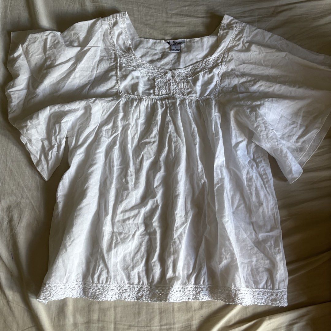 Coco Cabaña White Babydoll Eyelet Trim Top (Category: Blouses) located in Binan City. Submitted by myprelovedhaul (Listing ID 1468071228, Image 2). Description: This is a white cotton square-neck smock or babydoll blouse featuring flutter sleeves and delicate lace trim along the neckline and hem..