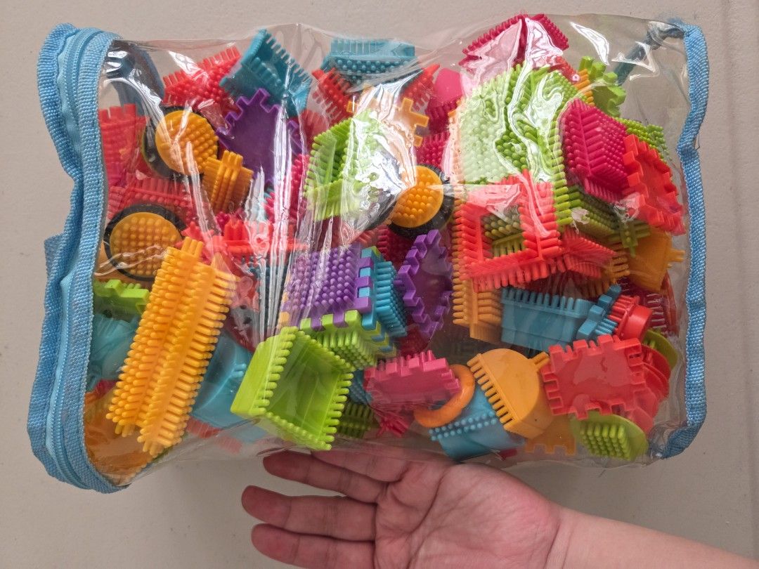 Colorful interlocking bristle blocks sensory construction toy set in bag (Category: Educational & Learning Toys) located in Quezon City. Submitted by robin.t (Listing ID 1468092043, Image 2). Description: - Multi-colored bristle blocks for endless creative building - Excellent tactile sensory toy that helps develop fine motor skills - Includes diverse shapes: squares, wheels, long connector sticks, and arches - Comes with a convenient clear plast