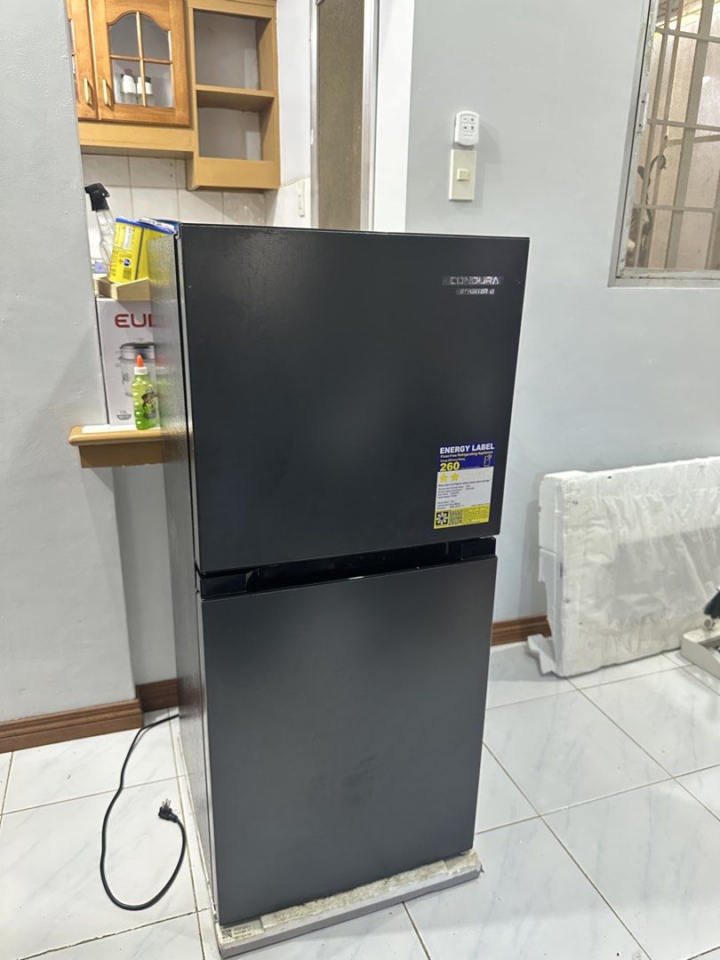 Condura CTF650i Inverter Refrigerator (Category: Refrigerators and Freezers) located in Cavite. Submitted by andreanico61694 (Listing ID 1468280578, Image 2). Description: - Brand/Model: Condura Inverter Refrigerator (CTF650i) - Type: Frost-free with energy label attached - Capacity: 179 liters total volume - Color: Sleek black finish - Features: Clean interior shelves, MAXI Fresh crisper drawer, and convenient door bins - Condition: Clean, well-