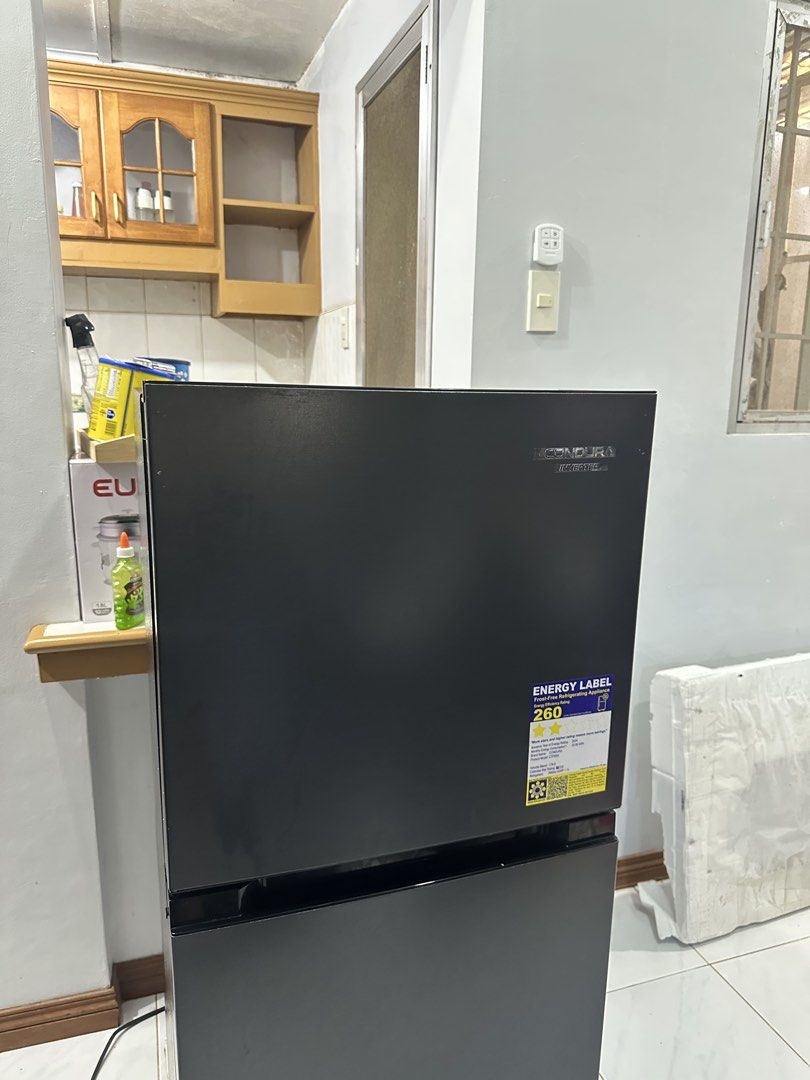 Condura CTF650i Inverter Refrigerator (Category: Refrigerators and Freezers) located in Cavite. Submitted by andreanico61694 (Listing ID 1468280578, Image 1). Description: - Brand/Model: Condura Inverter Refrigerator (CTF650i) - Type: Frost-free with energy label attached - Capacity: 179 liters total volume - Color: Sleek black finish - Features: Clean interior shelves, MAXI Fresh crisper drawer, and convenient door bins - Condition: Clean, well-
