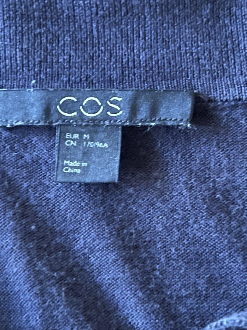 COS Black Cotton Silk Polo (Category: Blouses) located in Angeles City. Submitted by msr093 (Listing ID 1468126254, Image 3). Description: COS black polo in size M. Material is 55% silk and 45% cotton, super soft blend. Classic polo collar with two buttons. Ribbed cuffs and hem line. Minimalist style, great basic for layering or wearing on its own. EUR M sizing. L 24in x W 20in x Sleeve length 11in.