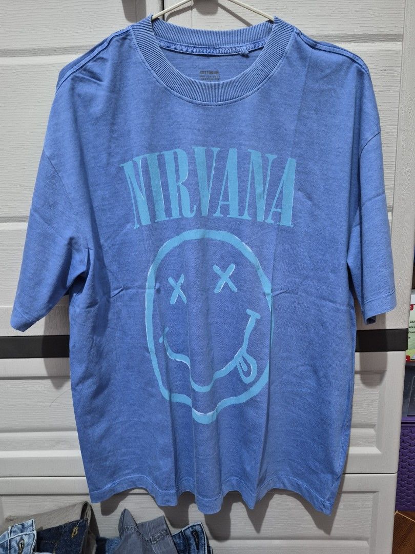 Cotton On Nirvana Graphic Tee Blue Size S (Category: Tshirts & Polo Shirts ) located in Antipolo. Submitted by prinsesa_dianne (Listing ID 1468247293, Image 1). Description: Cotton On boxy graphic tee in blue. Nirvana text and smiley face print on the front. Ribbed crew neck collar. Size S tag printed inside the collar. Made in Bangladesh. Comfortable everyday casual shirt..
