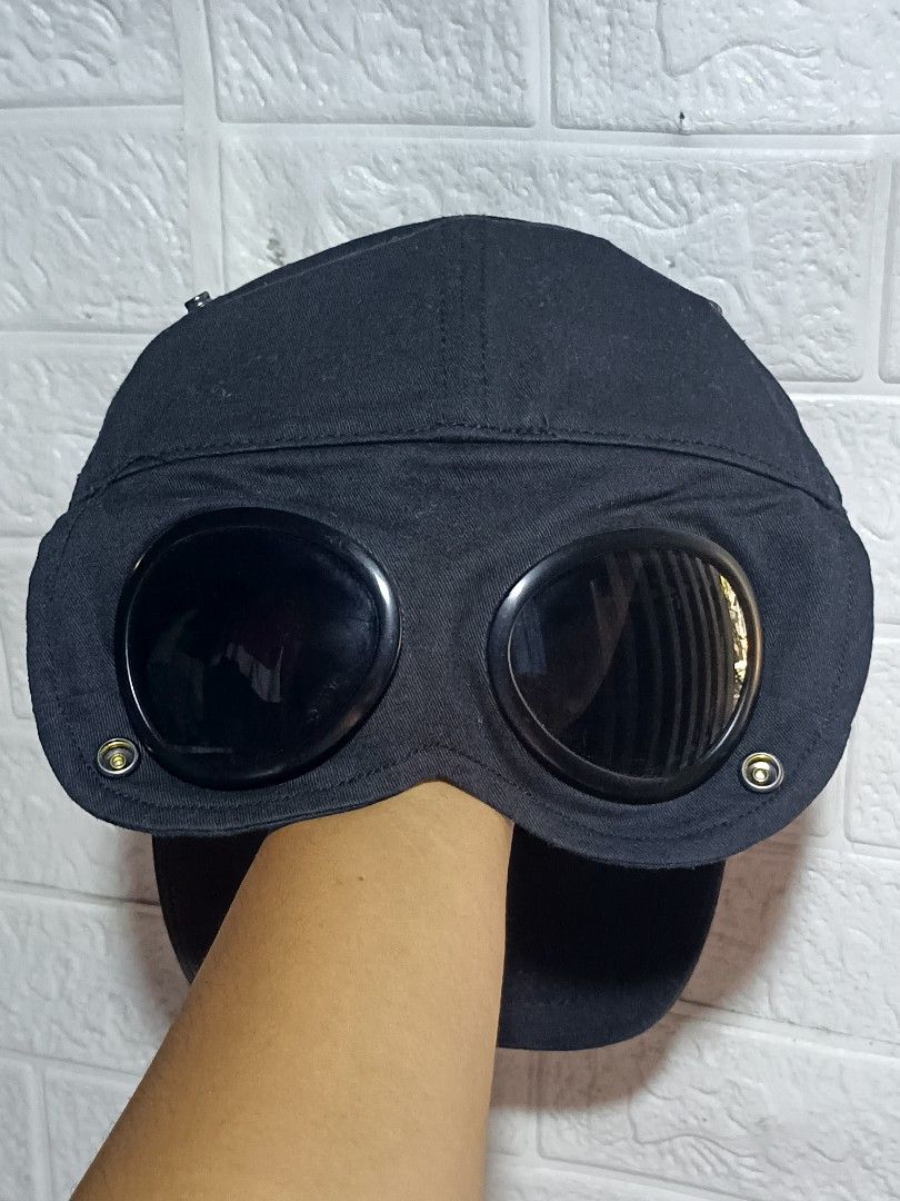 C.P. Company Goggle Baseball Cap Black Size M (Category: Caps & Hats) located in Caloocan City. Submitted by gemfinder669 (Listing ID 1468096248, Image 2). Description: - Brand: C.P. Company - Item: Baseball Cap - Color: Black - Size: M - Material: 100% cotton - Signature built-in goggles on the brim - Embroidered logo lettering on front panels - Interior brand tags and care labels completely intact - Country of manufacture: China - Production da