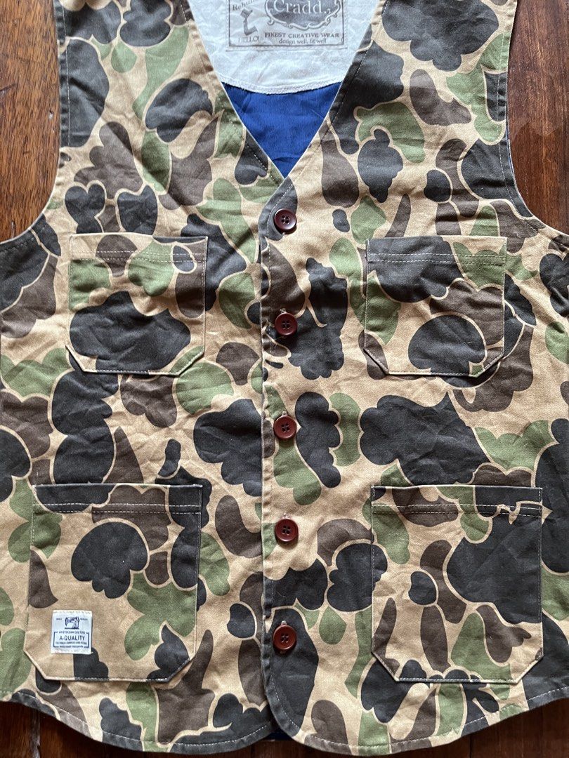 Cradd button-up utility vest featuring a classic duck hunter camouflage pattern (Category: Vests) located in Los Banos. Submitted by lootmeup (Listing ID 1468232584, Image 3). Description: Vintage Cradd button-up utility vest featuring a classic duck hunter camouflage pattern Size: Width: 18.5 Length: 25 Mine P500.