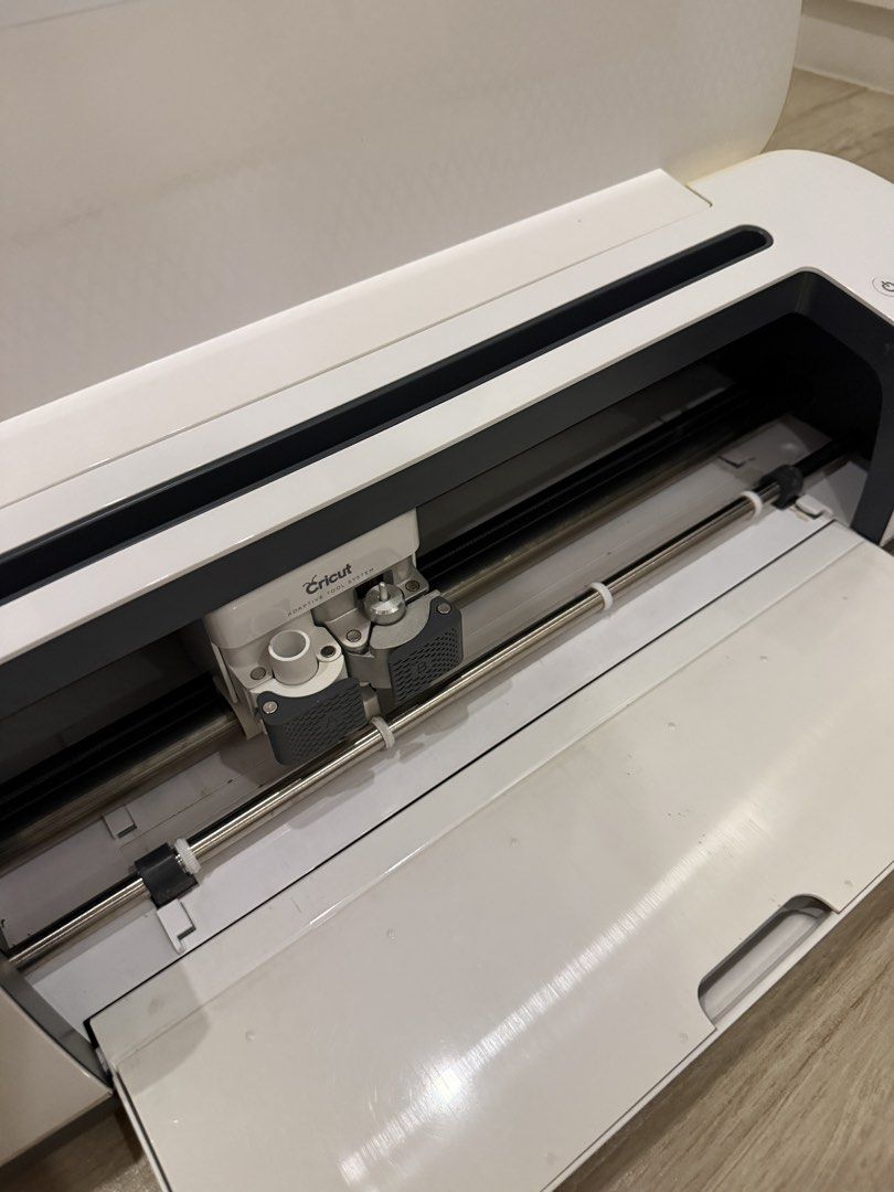 Cricut Maker Smart Cutting Machine (Category: Craft Supplies & Tools) located in Bacoor. Submitted by cts217 (Listing ID 1468185898, Image 3). Description: - Model: Cricut Maker - Condition: Clean body, fully functional buttons, yellowing due to sun exposure - Features dual carriage system for cutting, scoring, and writing tools - Equipped with built-in storage compartments on top and front panel - Includes original cables - Free sealed foil tran