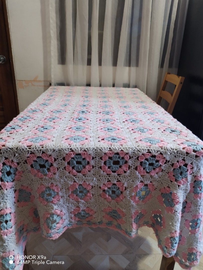 Crochet Table Topper ( 65 x 80 inches) (Category: Table Linen & Textiles) located in Muntinlupa City. Submitted by arciagamaryann68 (Listing ID 1468099629, Image 1). Description: - Item: Handmade Crochet Table Topper - Size: 65 x 80 inches - Design: Classic granny square / floral pattern in white, soft pink, and light blue - Condition: Excellent, clean, and well-kept - Ideal use: Dining table cover, living room centerpiece, or home decor accent.