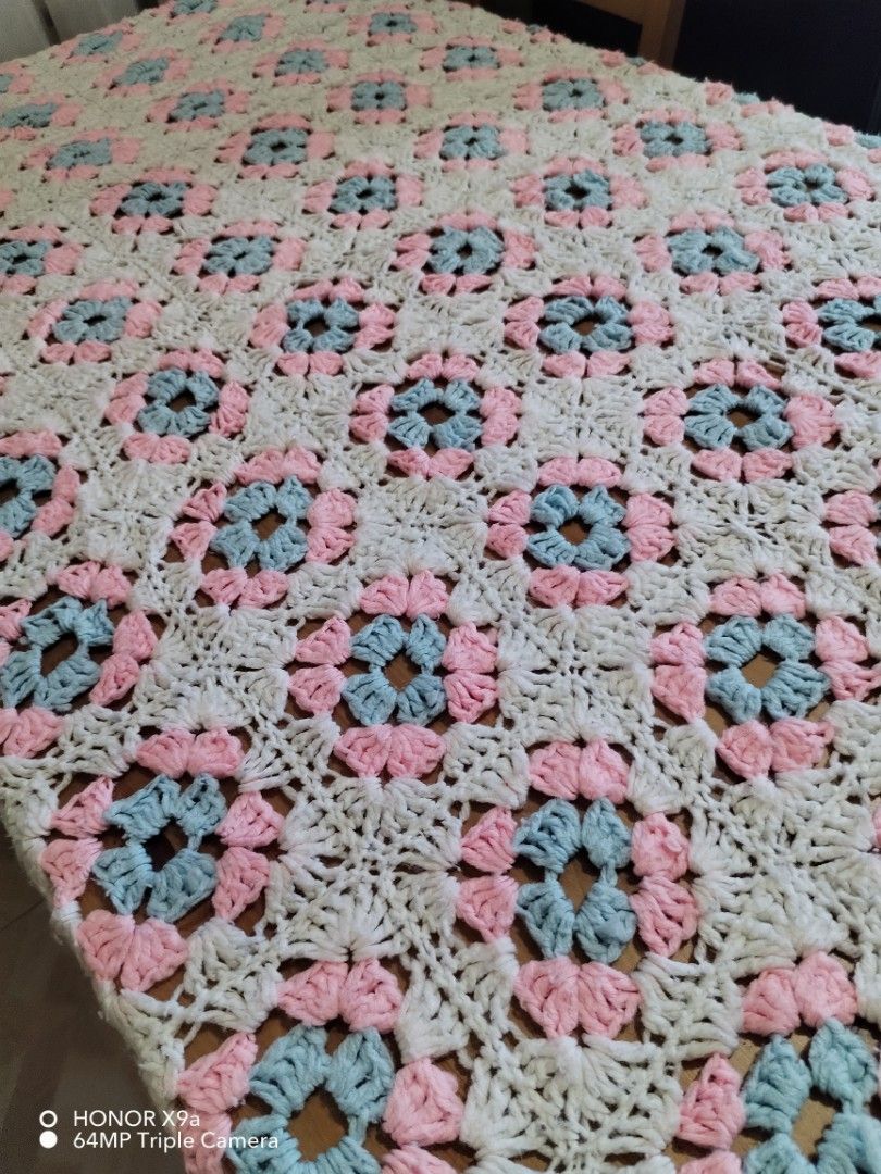 Crochet Table Topper ( 65 x 80 inches) (Category: Table Linen & Textiles) located in Muntinlupa City. Submitted by arciagamaryann68 (Listing ID 1468099629, Image 3). Description: - Item: Handmade Crochet Table Topper - Size: 65 x 80 inches - Design: Classic granny square / floral pattern in white, soft pink, and light blue - Condition: Excellent, clean, and well-kept - Ideal use: Dining table cover, living room centerpiece, or home decor accent.