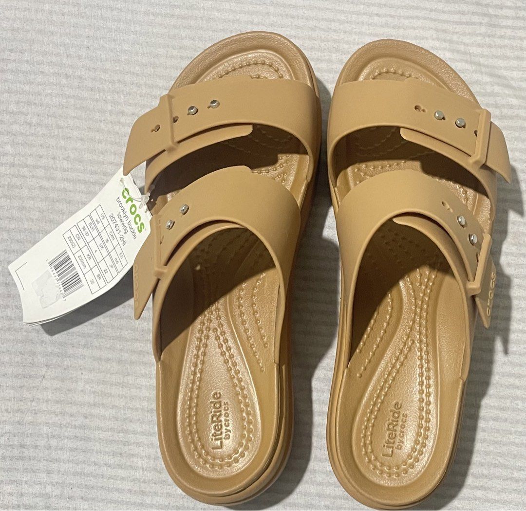 Crocs Brooklyn Buckle Low Wedge Sandals (Category: Flats & Sandals) located in Quezon City. Submitted by dtg30 (Listing ID 1468082634, Image 1). Description: - Brand: Crocs - 100% Authentic Crocs - Style: Brooklyn Buckle Low Wedge Sandals - Color: Tan - Condition: Brand new with tags (never worn) - Design: Two-strap with metallic button accents and adjustable buckle look - Comfort: Features plush LiteRide footbed for all-day wear - Heel: Wedge st