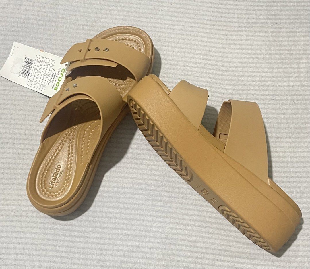 Crocs Brooklyn Buckle Low Wedge Sandals (Category: Flats & Sandals) located in Quezon City. Submitted by dtg30 (Listing ID 1468082634, Image 2). Description: - Brand: Crocs - 100% Authentic Crocs - Style: Brooklyn Buckle Low Wedge Sandals - Color: Tan - Condition: Brand new with tags (never worn) - Design: Two-strap with metallic button accents and adjustable buckle look - Comfort: Features plush LiteRide footbed for all-day wear - Heel: Wedge st