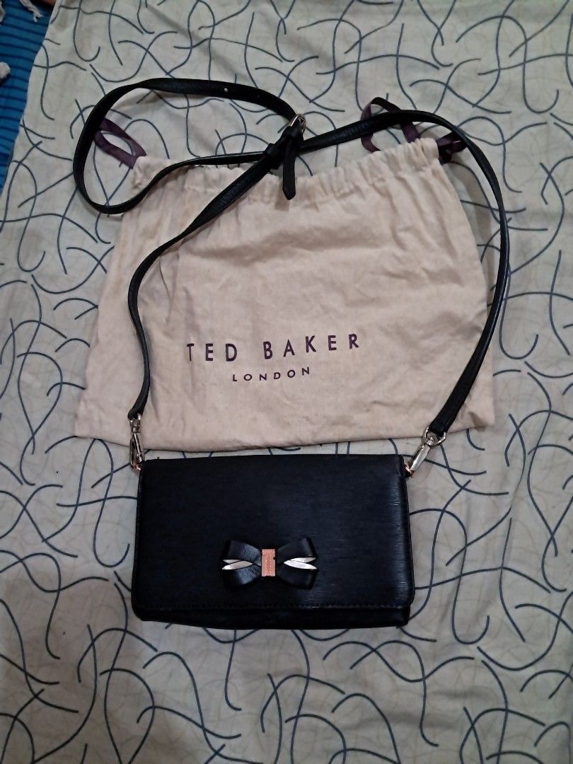 Crossbody bag Ted Baker London (Category: Cross-body Bags) located in Las Pinas. Submitted by shop2ship (Listing ID 1468100844, Image 1). Description: Ted Baker London crossbody bag strap is removable and adjustable with dustbag ribbon detail in front has 8 slots for cards with coin slots with zipper.