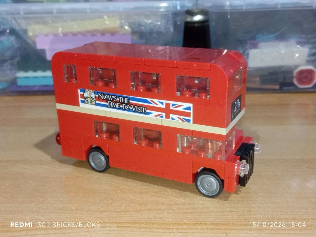 Custom Built London Double Decker Bus Brick Toy (Category: Vehicle & Diecast Models) located in Manila. Submitted by jynxpedrin39963 (Listing ID 1468218351, Image 2). Description: - Custom red double-decker bus building block set - Features unique stickers: 'THE BRICK SEPARATOR' and 'NOW'S THE TIME TO VISIT!' - Detailed with British flags, custom license plates, grey wheels, black front grille, and transparent windows - Excellent display piece fo