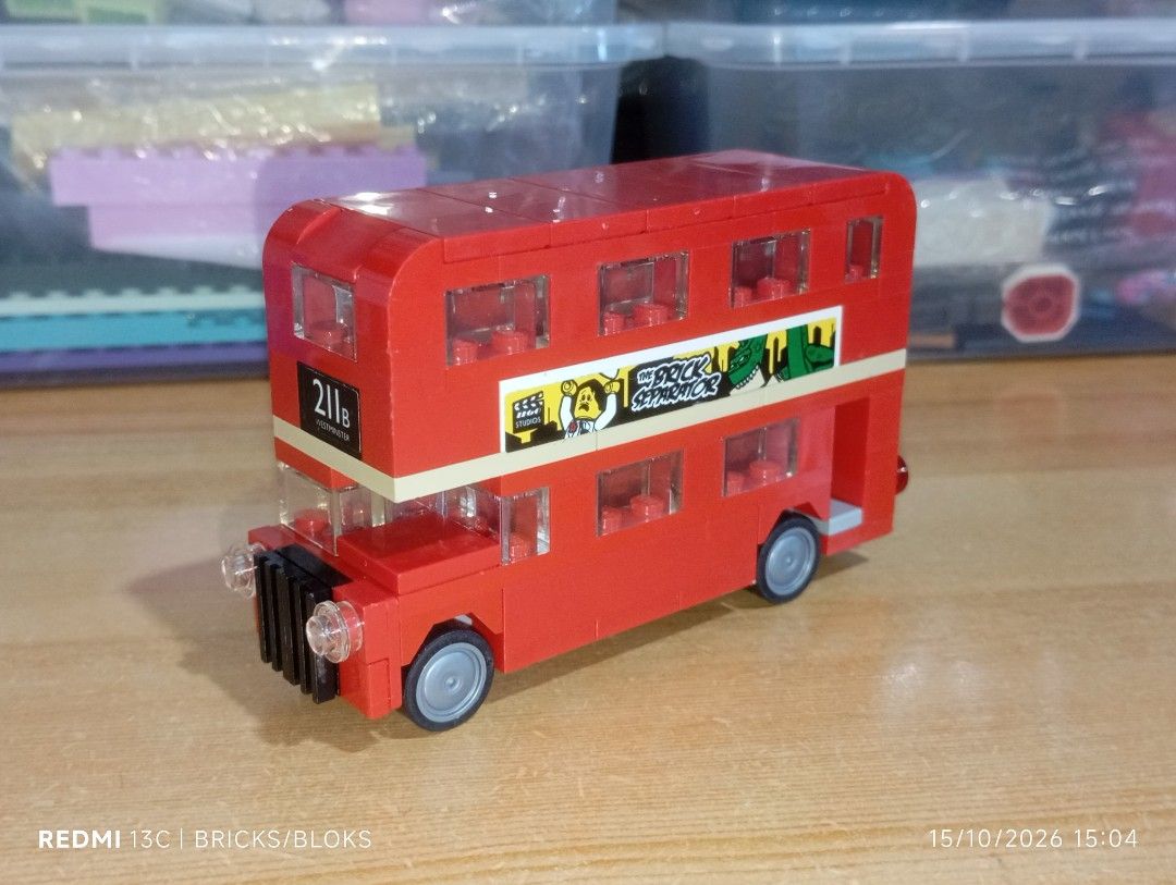 Custom Built London Double Decker Bus Brick Toy (Category: Vehicle & Diecast Models) located in Manila. Submitted by jynxpedrin39963 (Listing ID 1468218351, Image 1). Description: - Custom red double-decker bus building block set - Features unique stickers: 'THE BRICK SEPARATOR' and 'NOW'S THE TIME TO VISIT!' - Detailed with British flags, custom license plates, grey wheels, black front grille, and transparent windows - Excellent display piece fo