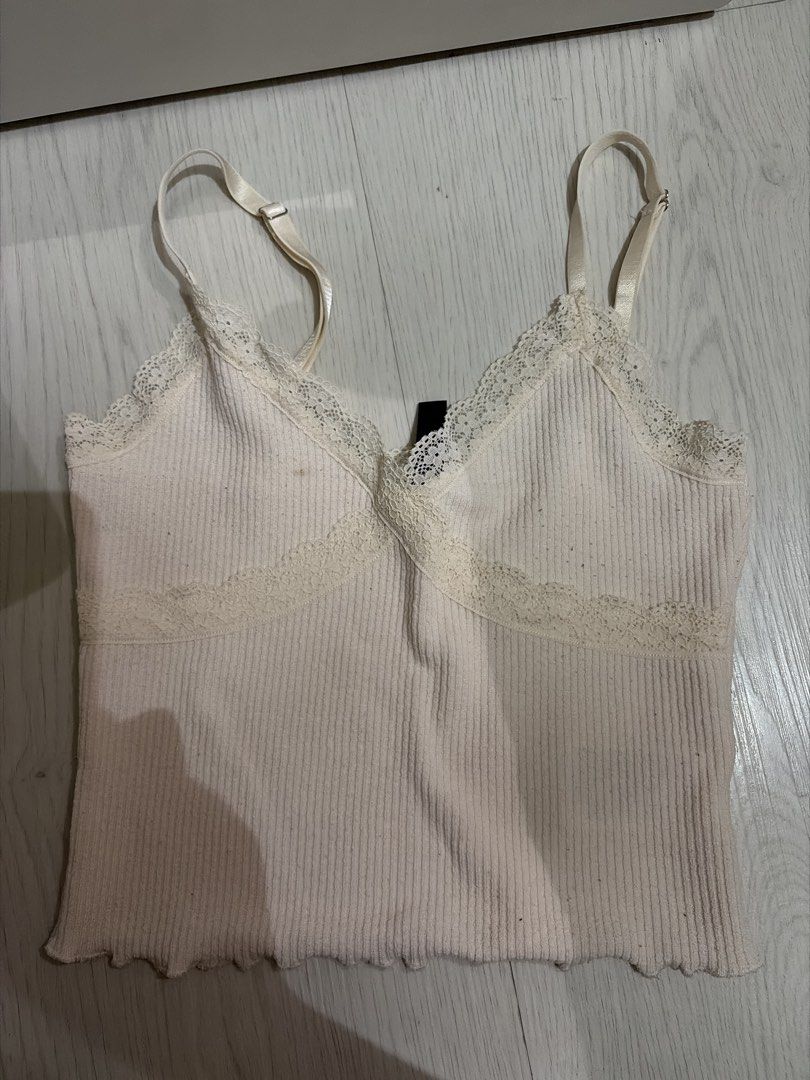 cute top Camisole With Lace Trim (Category: Sleeveless) located in Taguig. Submitted by nics04433 (Listing ID 1468153911, Image 1). Description: - Color: Cream - Style: Ribbed camisole basic top - Details: Adjustable spaghetti straps, delicate lace trim V-neck, cute lettuce hem - Fabric: Soft, stretchable knit .