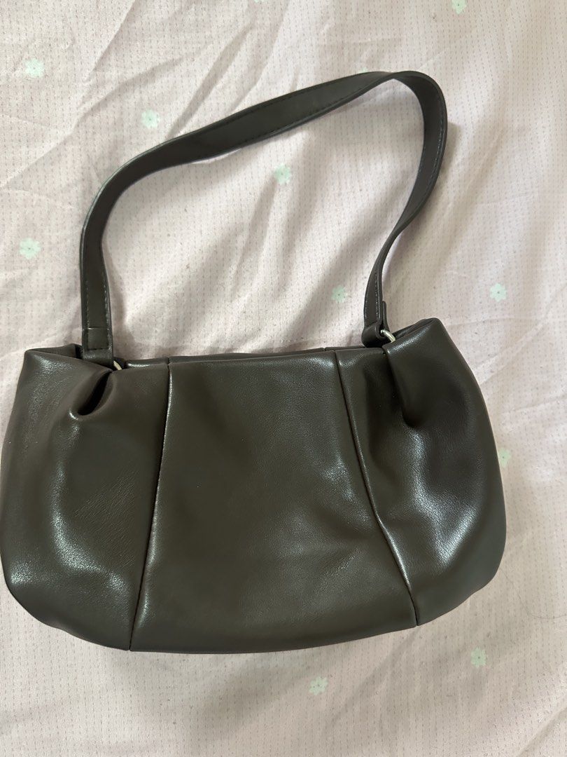 Dark Brown PU Leather Shoulder Bag (Category: Shoulder Bags) located in Lipa City. Submitted by chiechums (Listing ID 1468105477, Image 1). Description: - Color & Material: Dark brown smooth faux leather - Design: Structured pleated style with paneling details and silver-tone hardware - Closure: Secure magnetic snap top closure - Interior: Clean beige fabric lining with one handy zippered pocket - Condition: Clean inside and out, ready to use.