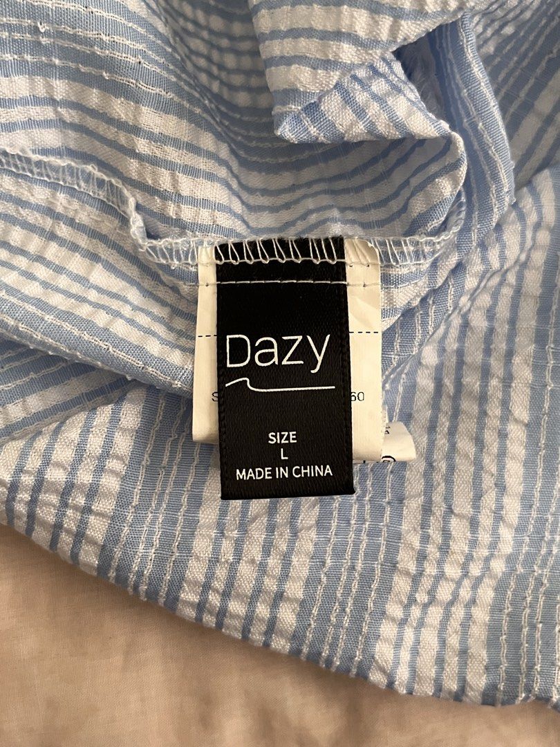 Dazy Blue and White Striped Camisole Size L (Category: Sleeveless) located in Marikina City. Submitted by yeun0923 (Listing ID 1468099430, Image 3). Description: - GCASH MOP - Buyer handles SF - JRS or Lalamove - Style: V-neckline with adjustable tie-up shoulder straps - Material: Lightweight crinkled fabric - Condition: Clean and ready to wear.