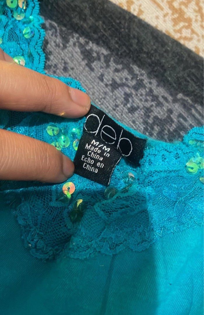 Deb Teal Camisole top with Lace and Sequins Medium (Category: Sleeveless) located in Lapu Lapu. Submitted by ruby_welly22 (Listing ID 1468264046, Image 2). Description: - Brand: Deb - Size: Medium - Color: Bright teal - Details: Delicate lace trim and sparkling sequins on neckline and hem - Straps: Adjustable spaghetti straps - Material: Lightweight, flowy fabric - Best for: Parties and casual outings - Condition: Excellent.