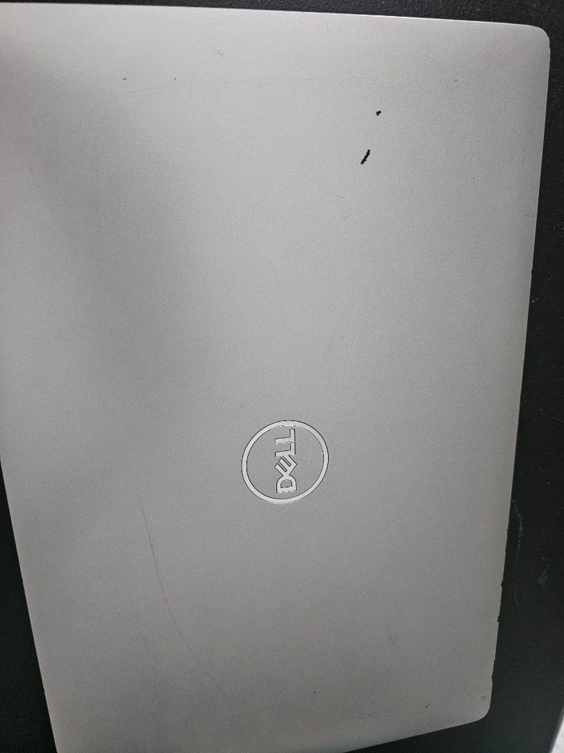 Dell Laptop Silver (Category: Laptops & Notebooks) located in Makati City. Submitted by ginashy (Listing ID 1468096432, Image 3). Description: some gasgas and peel off rubber side of the screen (check on the picture) loc: makati.