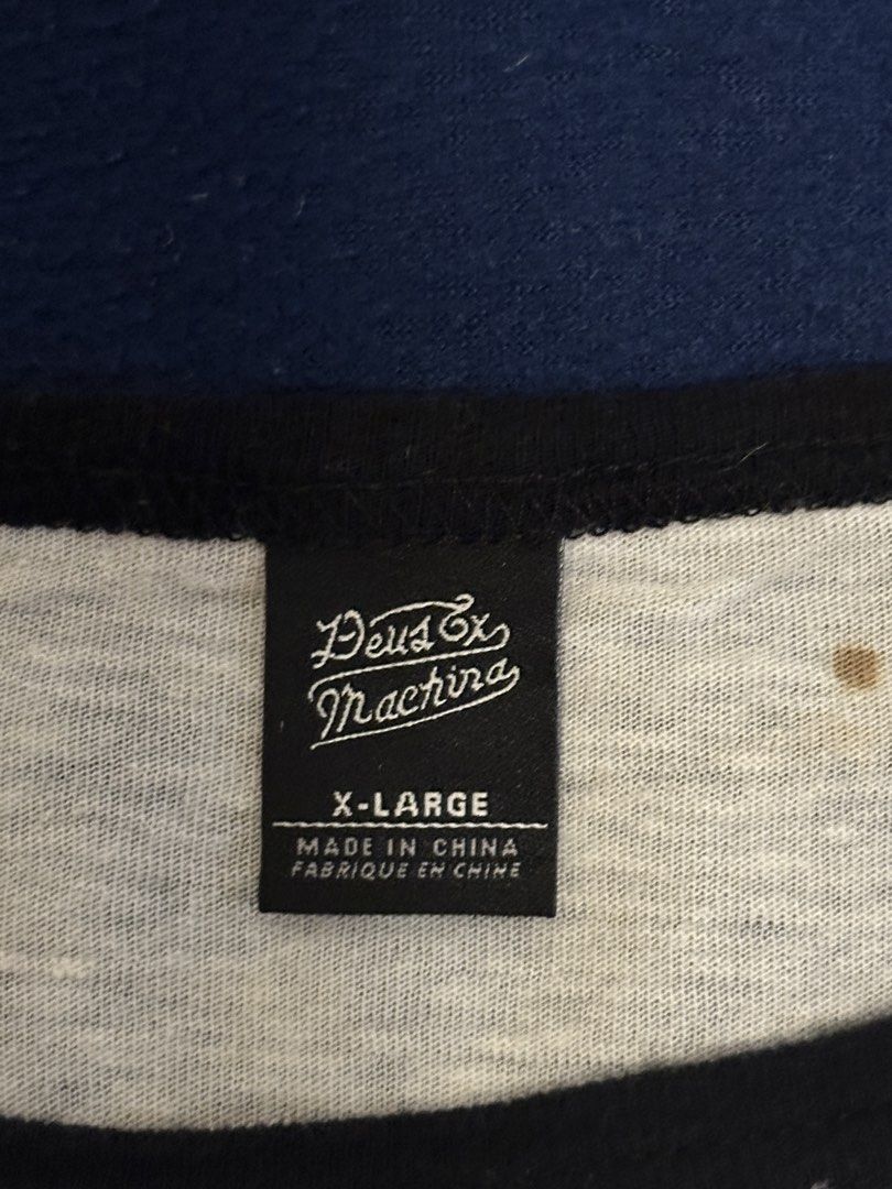 Deus ex Machina (Category: Activewear) located in Quezon City. Submitted by mancave_stuff (Listing ID 1468155154, Image 3). Description: Deus ex Machina 3/4 long sleeves Size XL (W22” x L25”) • Style: Raglan-sleeve baseball shirt with contrasting dark sleeves and a light body. • Graphic: A custom illustration with script text reading “Everyday” and a surfboard graphic displaying the DEUS name, associated with the lifestyle and moto-surf brand Deu