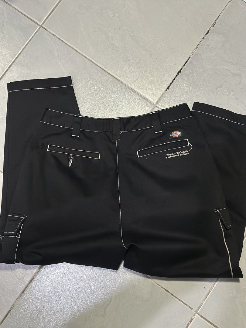 Dickies Contrast Stitch Cargo Pants Black (Category: Trousers) located in Makati City. Submitted by its.ptrck (Listing ID 1468119152, Image 3). Description: - Brand: Dickies - Color: Black with contrast white stitching - Details: Unique brand history graphic prints near pockets (1922 Williamson-Dickie, vehicle & harness business history) - Pockets: Multiple utility pockets plus a back button pocket - Fit: Straight leg cut - Style: Casual streetwe