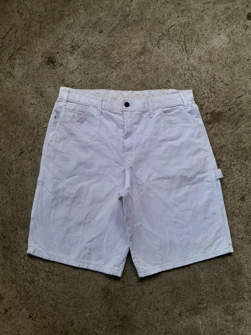 Dickies Dunn-Edwards Paints White Carpenter Shorts (Category: Shorts) located in Bayabas. Submitted by justhriftwithme (Listing ID 1468068531, Image 2). Description: - Brand: Dickies x Dunn-Edwards Paints - Style: White carpenter shorts with vintage look - Features: Rare back pocket collaboration patch, classic hammer loop, and utility pockets - Hardware: Button closure with embossed logo branding - Material: Durable cotton canvas - Fit: Great st