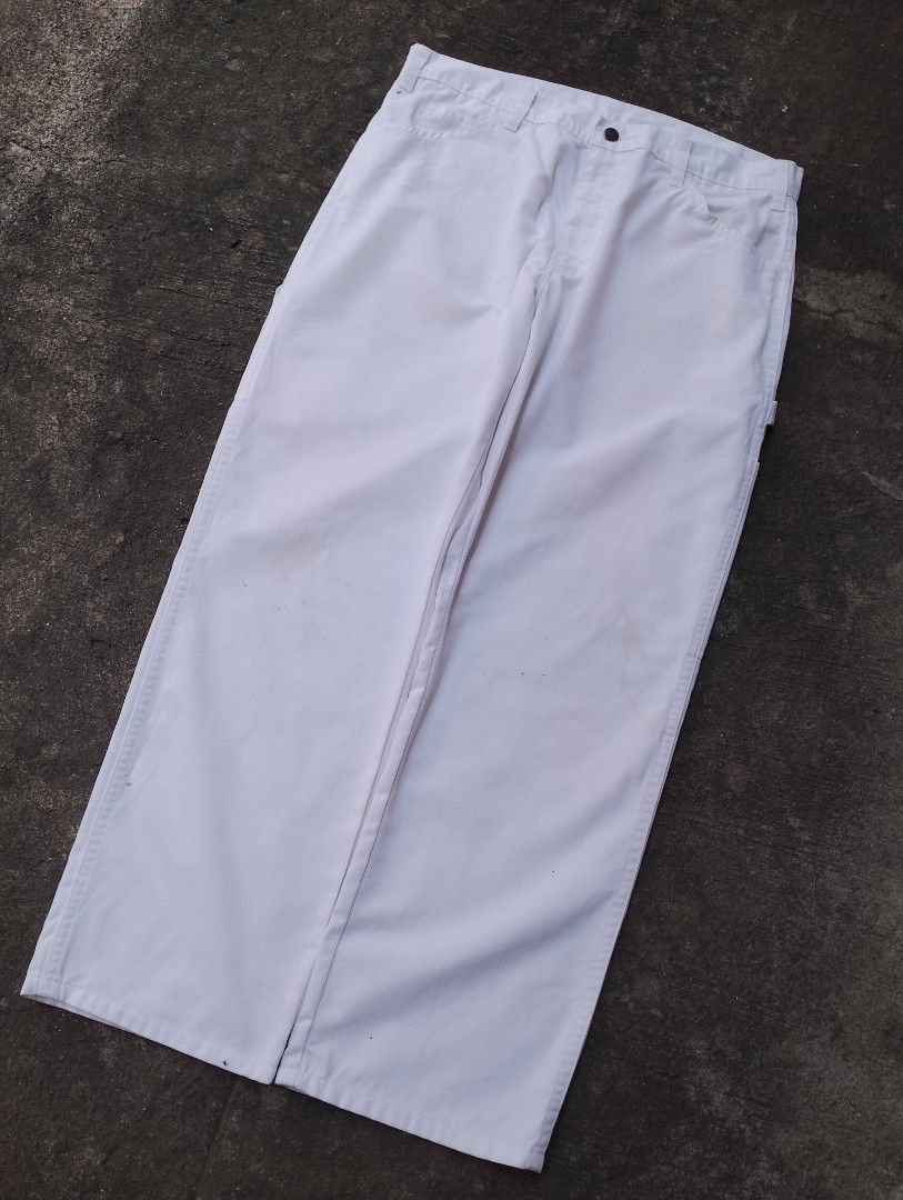 Dickies White Painter Utility Cargo Pants (Category: Jeans) located in Bago City. Submitted by the_outcast6101 (Listing ID 1468278293, Image 3). Description: - Brand: Dickies - Style: White carpenter work pants with side pockets, hammer loop, and iconic logo patch - Fit: Classic relaxed fit - Material: Heavy-duty cotton duck - Condition: Noticeable paint stains near the front knee area (as pictured) - Perfect for: Painting, skating, or streetwear