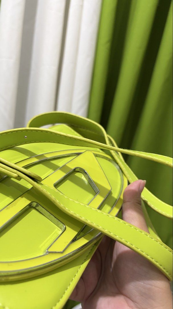 Diesel Flourescent Green Shoulder Bag (Category: Luxury Bags & Wallets) located in Manila. Submitted by wandathescarletwitch (Listing ID 1468059724, Image 3). Description: - Brand: Diesel - Color: Flourescent green - Hardware: Silver-tone - Details: Signature metal D logo plate on flap closure, smooth finish - Strap: Adjustable matching strap - Shape: Compact rectangular.