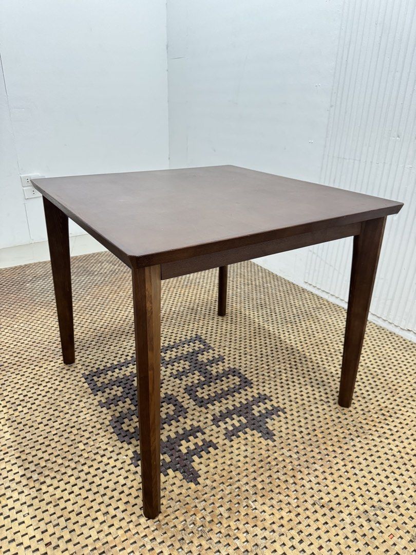 Dining Table (Category: Tables & Sets) located in Quezon City. Submitted by matetdevis13 (Listing ID 1468235239, Image 2). Description: Classic Dark Brown Square Wooden Dining Table Price: 4,900 L31.5 x H27.5 In good condition Code JMD12-M465 It features a simple, flat tabletop and four straight legs, making it suitable for dining areas, kitchens, or multipurpose spaces..