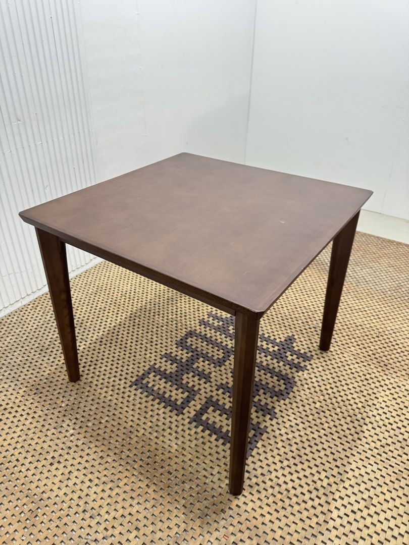 Dining Table (Category: Tables & Sets) located in Quezon City. Submitted by matetdevis13 (Listing ID 1468235239, Image 3). Description: Classic Dark Brown Square Wooden Dining Table Price: 4,900 L31.5 x H27.5 In good condition Code JMD12-M465 It features a simple, flat tabletop and four straight legs, making it suitable for dining areas, kitchens, or multipurpose spaces..