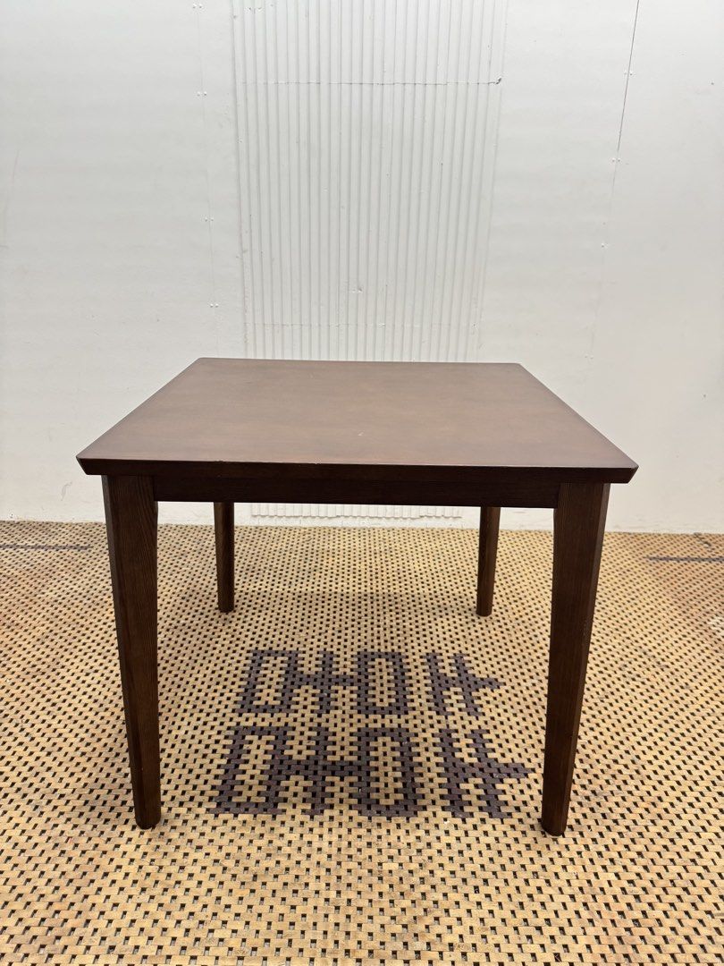 Dining Table (Category: Tables & Sets) located in Quezon City. Submitted by matetdevis13 (Listing ID 1468235239, Image 1). Description: Classic Dark Brown Square Wooden Dining Table Price: 4,900 L31.5 x H27.5 In good condition Code JMD12-M465 It features a simple, flat tabletop and four straight legs, making it suitable for dining areas, kitchens, or multipurpose spaces..