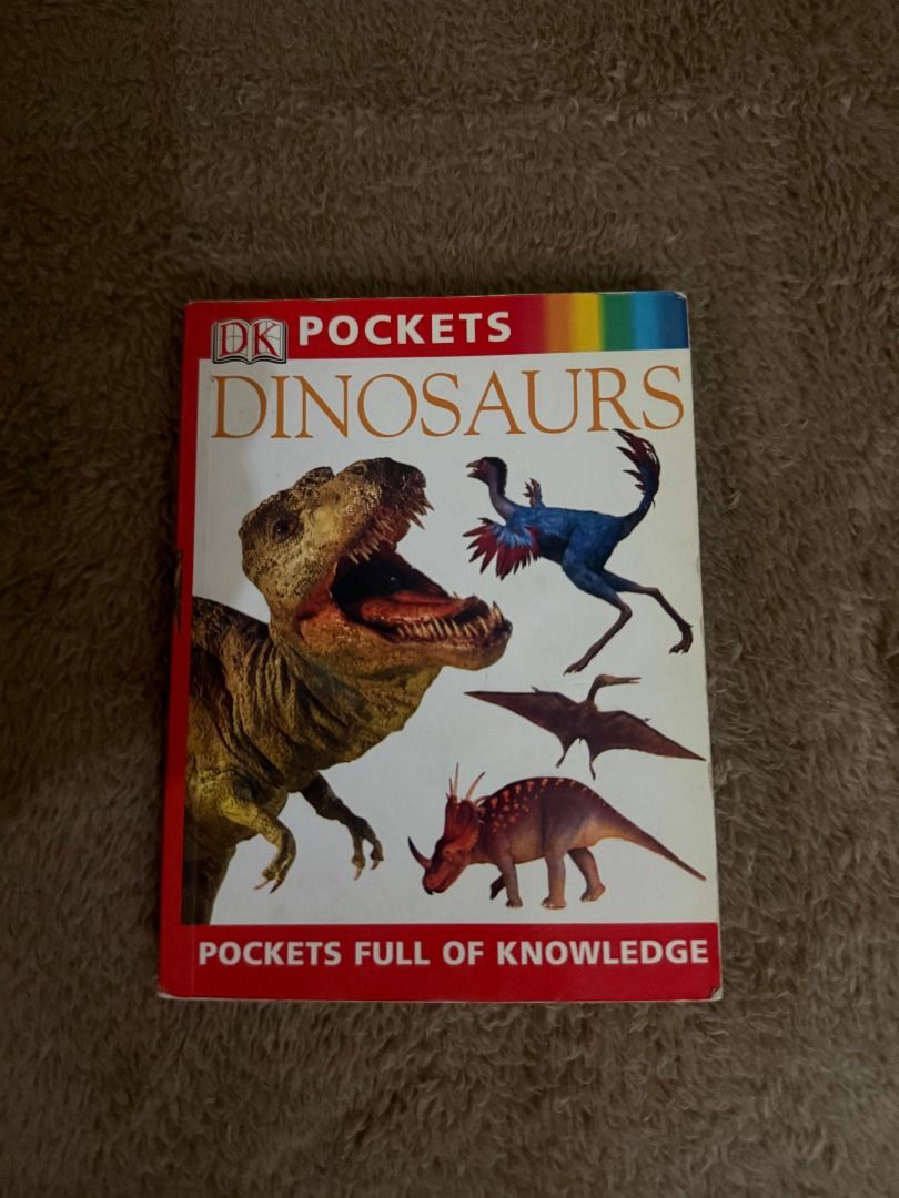 DK Pockets Dinosaur (Category: Children's Books) located in Manila. Submitted by vaultfinds (Listing ID 1468210690, Image 1). Description: DK Pockets Dinosaurs book from the Pockets Full of Knowledge series. Compact size filled with dinosaur facts, illustrations, and information. Great reference guide for young readers or dinosaur enthusiasts. Cover shows standard shelf wear along the edges and corners, binding remains solid..