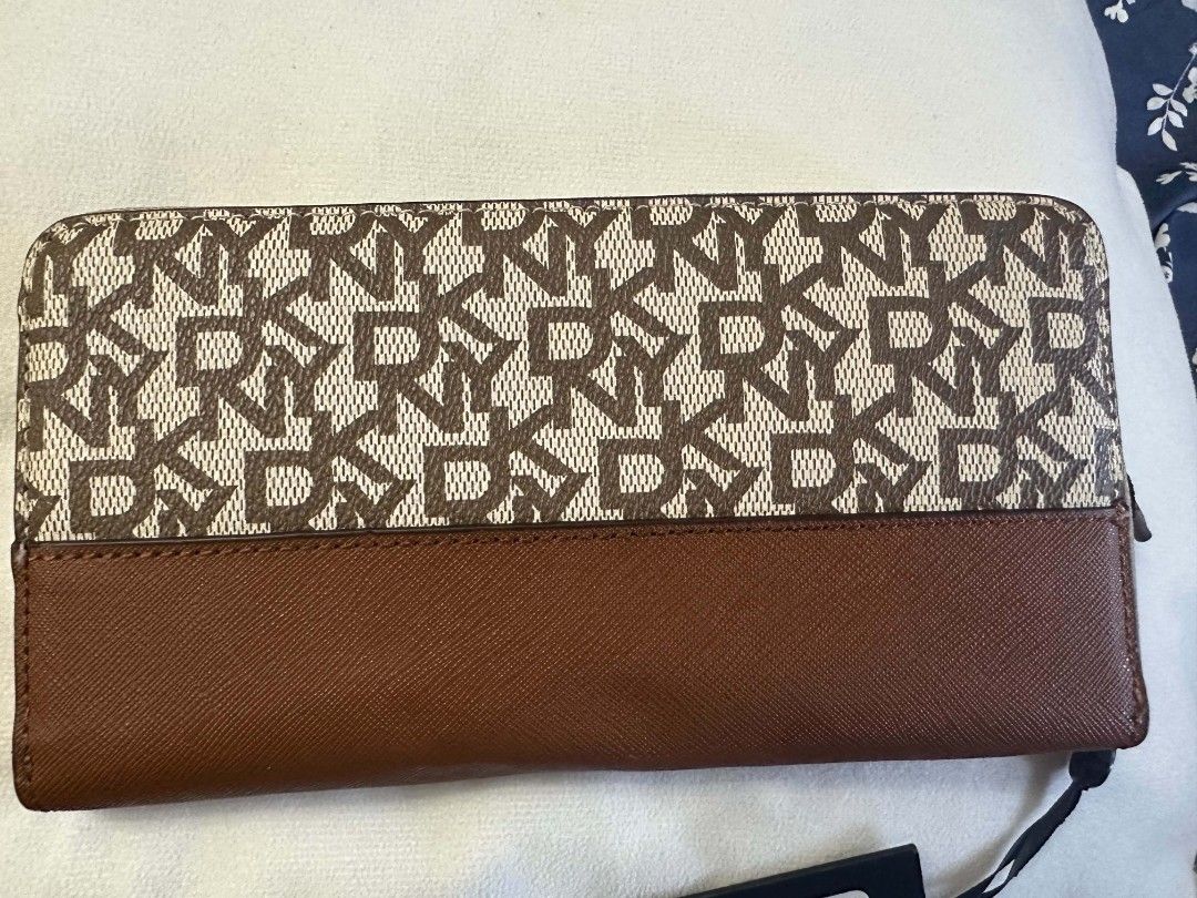 Dkny (Category: Wallets & Card holders) located in Cabanatuan. Submitted by Valeriecllctn (Listing ID 1468102230, Image 3). Description: DKNY Vela Zip Around Print Logo Pattern Wallet Tan R131YG36 8" X 5" - BRAND NEW. ₱1,999 only Features: 2 Main Compartment 2 Bill Compartment 8 Credit Card Holder 1 Zip Compartment 1 DKNY Gold Plated Logo Retail Price: $118.00.