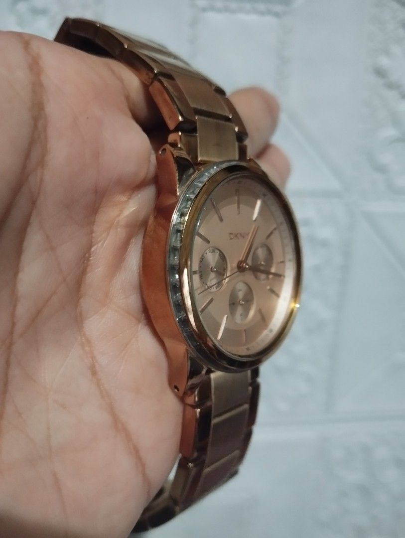 DKNY Rose Gold Chronograph Watch (Category: Women's Watches) located in Cabanatuan. Submitted by cmercado81243 (Listing ID 1468148499, Image 2). Description: - Brand: DKNY - Color: Elegant rose gold - Dial: Round face with 3 sub-dials (day, date, and 24-hour time) - Details: Textured crown and dual pushers - Strap: Metal link bracelet with polished finish - Condition: Pre-loved with minor wear on the bezel and links - Perfect for everyday wear or