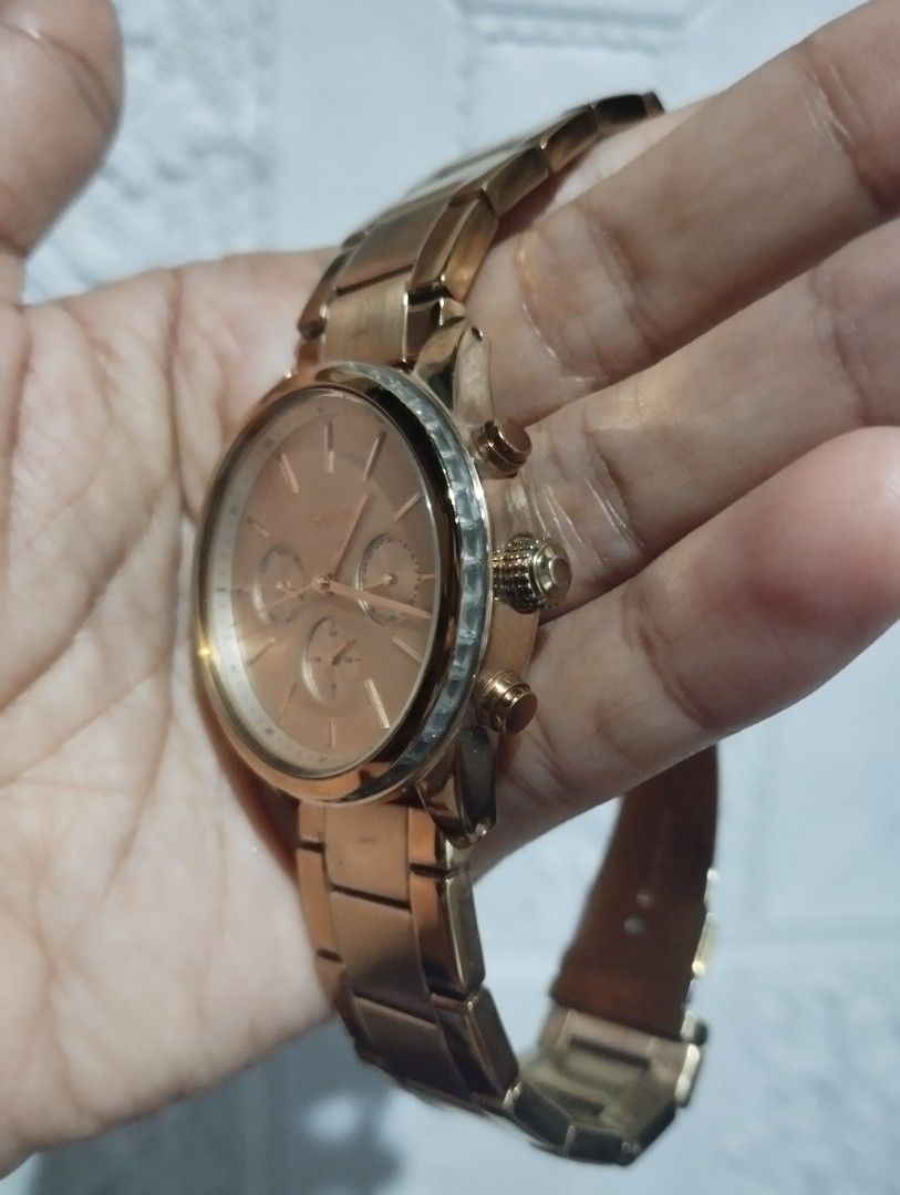 DKNY Rose Gold Chronograph Watch (Category: Women's Watches) located in Cabanatuan. Submitted by cmercado81243 (Listing ID 1468148499, Image 3). Description: - Brand: DKNY - Color: Elegant rose gold - Dial: Round face with 3 sub-dials (day, date, and 24-hour time) - Details: Textured crown and dual pushers - Strap: Metal link bracelet with polished finish - Condition: Pre-loved with minor wear on the bezel and links - Perfect for everyday wear or