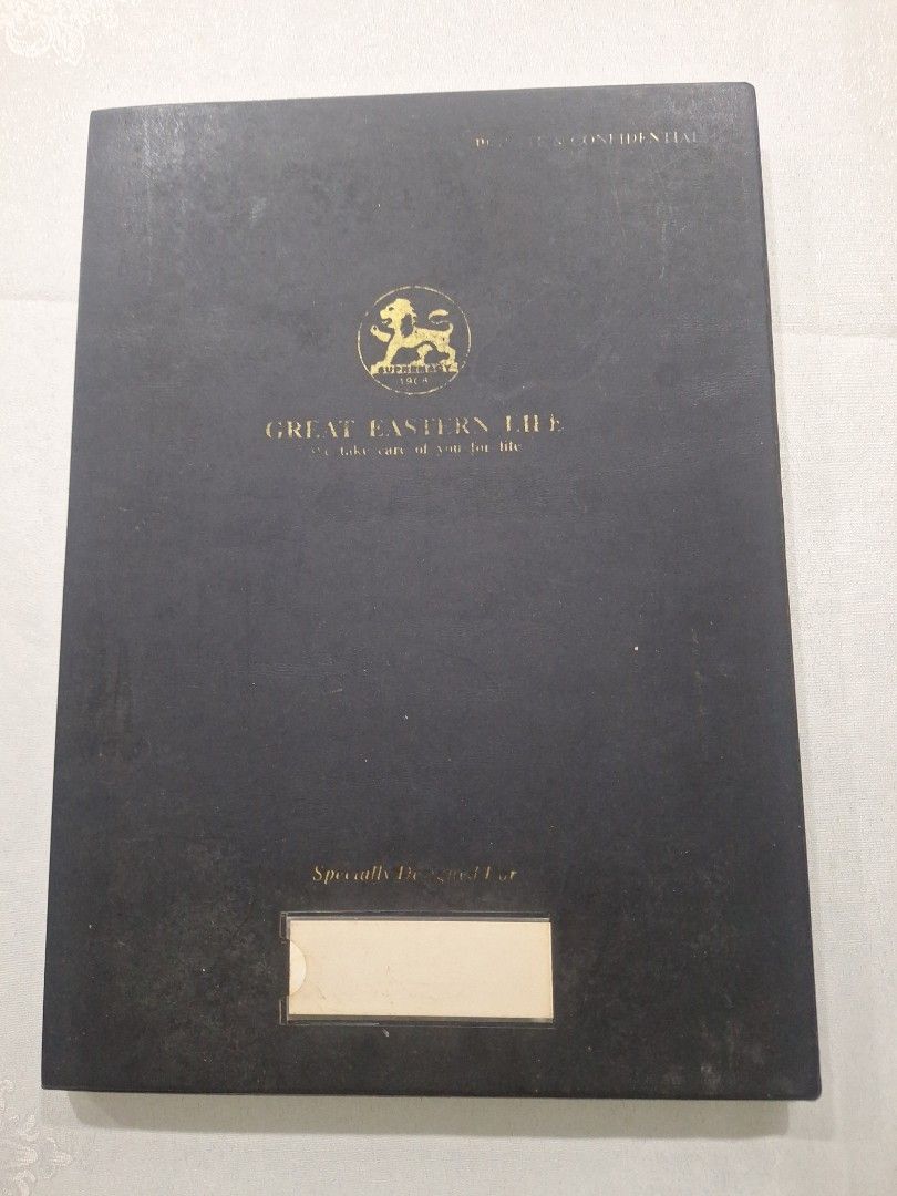 Document Folder - 10 pockets (Category: Stationery & School Supplies) located in Singapore. Submitted by jane101929 (Listing ID 1468239054, Image 1). Description: Black document folder with gold embossed Great Eastern Life logo on front. Includes clear plastic sleeves inside for organizing papers or certificates. Clear pocket slot on front cover for label insertion. Professional corporate item. Good for keeping documents neat and tidy. Hard cover