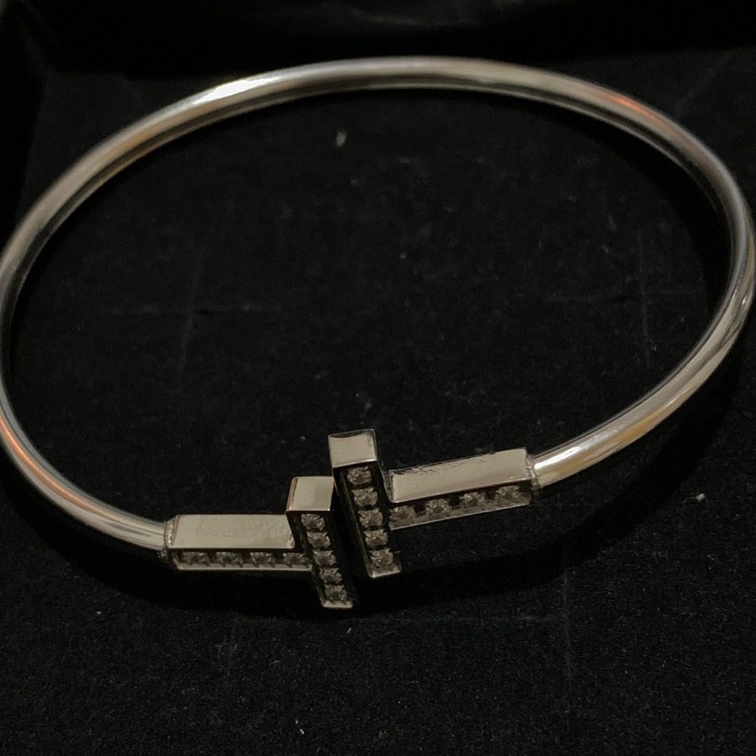 Double T Diamond and Mini stones Bangle Set (Category: Bracelets) located in Quezon City. Submitted by itscxyy (Listing ID 1468064897, Image 2). Description: - Stainless steel hinged bangle set - Paved with sparkling cubic zirconia and continuous channel-set square crystals - Features a secure and reliable clasp closure - Versatile piece ideal for daily wear or special outings.