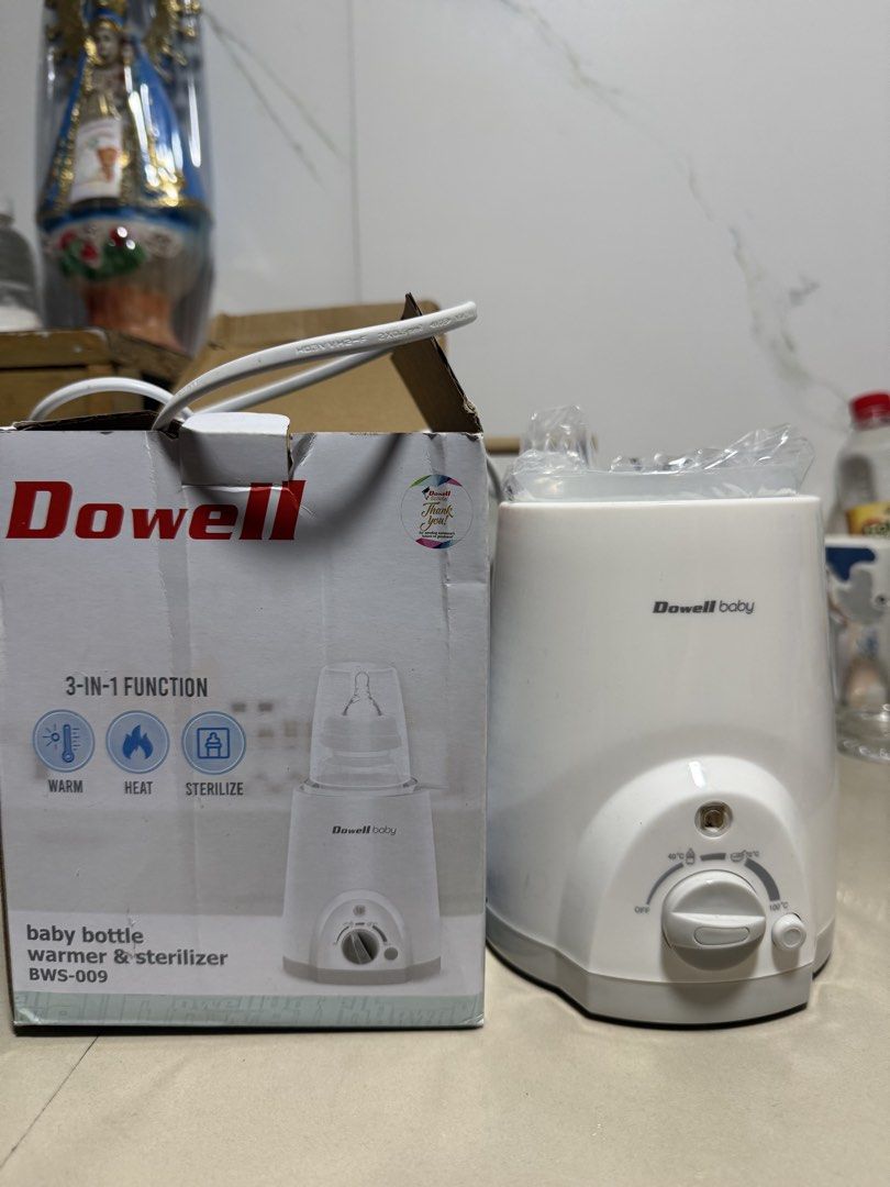 Dowell Baby Bottle Warmer & Sterilizer BWS-009 (Category: Breastfeeding & Bottle Feeding) located in Quezon City. Submitted by thedonnacn (Listing ID 1468222769, Image 2). Description: Dowell baby bottle warmer and sterilizer, model BWS-009. 3-in-1 function including warm, heat, and sterilize. Easy temperature settings from 40 degrees C to 100 degrees C. Includes original box, manual, and inner plastic wrap. 230V, 60Hz. Never used, stored in box.