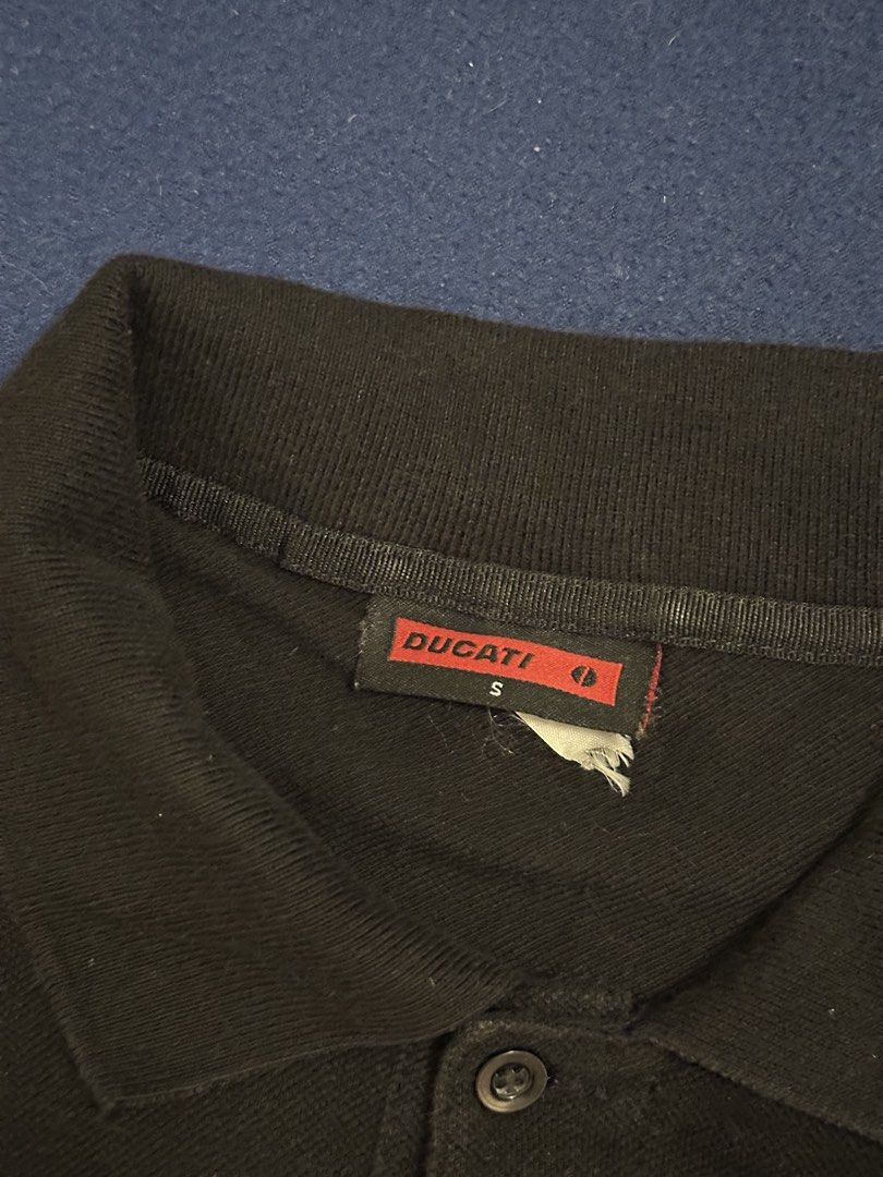 Ducati polo shirt (Category: Tshirts & Polo Shirts ) located in Quezon City. Submitted by mancave_stuff (Listing ID 1468185138, Image 3). Description: Ducati Performance short-sleeve polo shirt in a classic solid black colorway. Perfect for casual streetwear, bike meets, or everyday casual wear. • Condition: Preloved / Well-used (Shows normal signs of wear, giving it a great vintage look, but no major flaws) • Design: Clean minimalist look featur