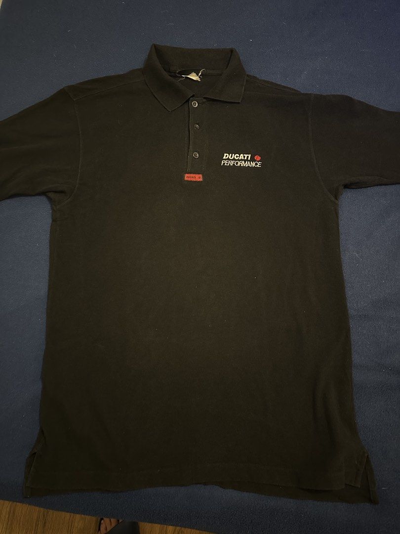 Ducati polo shirt (Category: Tshirts & Polo Shirts ) located in Quezon City. Submitted by mancave_stuff (Listing ID 1468185138, Image 1). Description: Ducati Performance short-sleeve polo shirt in a classic solid black colorway. Perfect for casual streetwear, bike meets, or everyday casual wear. • Condition: Preloved / Well-used (Shows normal signs of wear, giving it a great vintage look, but no major flaws) • Design: Clean minimalist look featur
