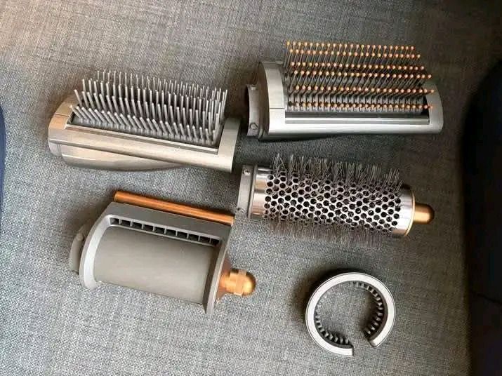 Dyson Airwrap Multi-Styler Complete (Category: Hair) located in Pagadian. Submitted by mamithere (Listing ID 1468110817, Image 3). Description: - Complete hair styling set with presentation case - Includes main styler handle, multiple barrels, and brushes - Features a stylish ceramic copper and nickel colorway - Comes with a filter cleaning brush and all original attachments - Fully functional and well-maintained multi-styler system.