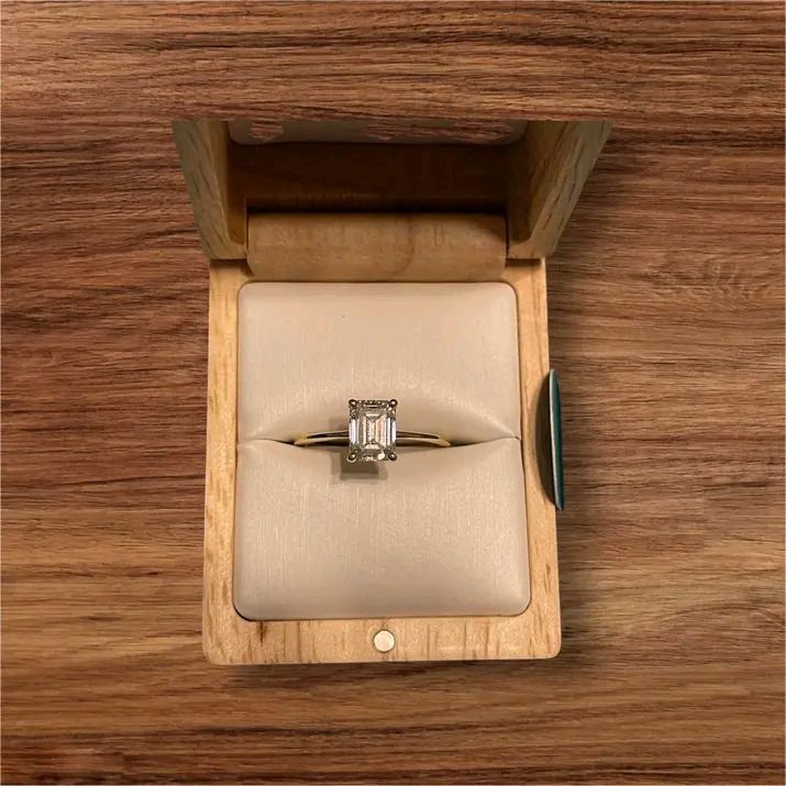 Emerald Cut Diamond Ring Gold Band (Category: Rings) located in Pagadian. Submitted by mamithere (Listing ID 1468107954, Image 1). Description: - Elegant minimalist design with a thin yellow gold band - Stunning rectangular emerald-cut stone in a secure four-prong setting - Clean, highly polished metal finish with a clear, light-reflecting gemstone - Includes a premium wooden presentation box featuring a cream velvet interior slot - Perfect for g