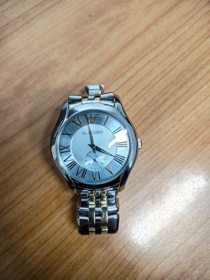 Emporio Armani AR-1044 (Category: Women's Watches) located in Paranaque City. Submitted by hungrypolarbear (Listing ID 1468282135, Image 3). Description: - Brand: Emporio Armani wrist watch AR-1044 - Color: Elegant silver and gold tone finish - Dial: Textured background with classic Roman numeral hour markers and small second sub-dial at the lower right - Strap: Metal link bracelet with alternating silver and gold links - Condition/Details: Clean