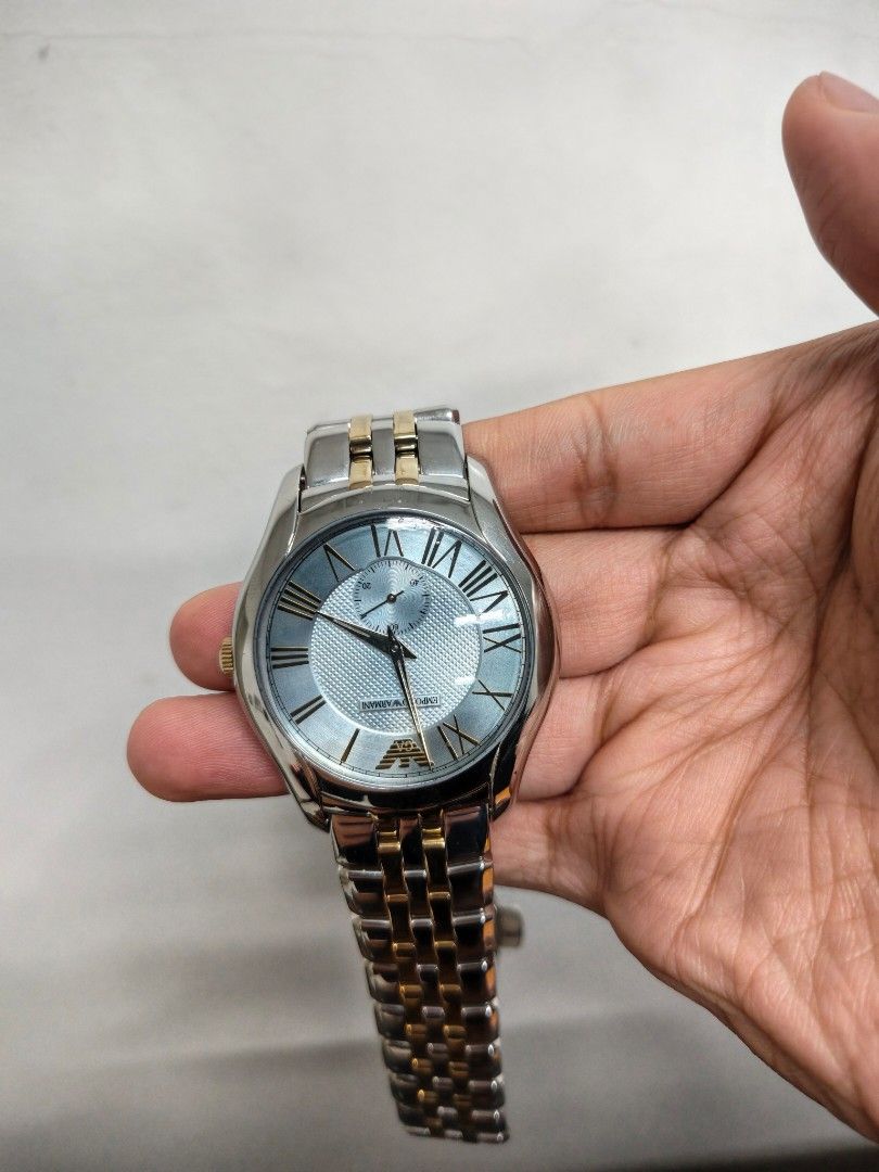 Emporio Armani AR-1044 (Category: Women's Watches) located in Paranaque City. Submitted by hungrypolarbear (Listing ID 1468282135, Image 2). Description: - Brand: Emporio Armani wrist watch AR-1044 - Color: Elegant silver and gold tone finish - Dial: Textured background with classic Roman numeral hour markers and small second sub-dial at the lower right - Strap: Metal link bracelet with alternating silver and gold links - Condition/Details: Clean