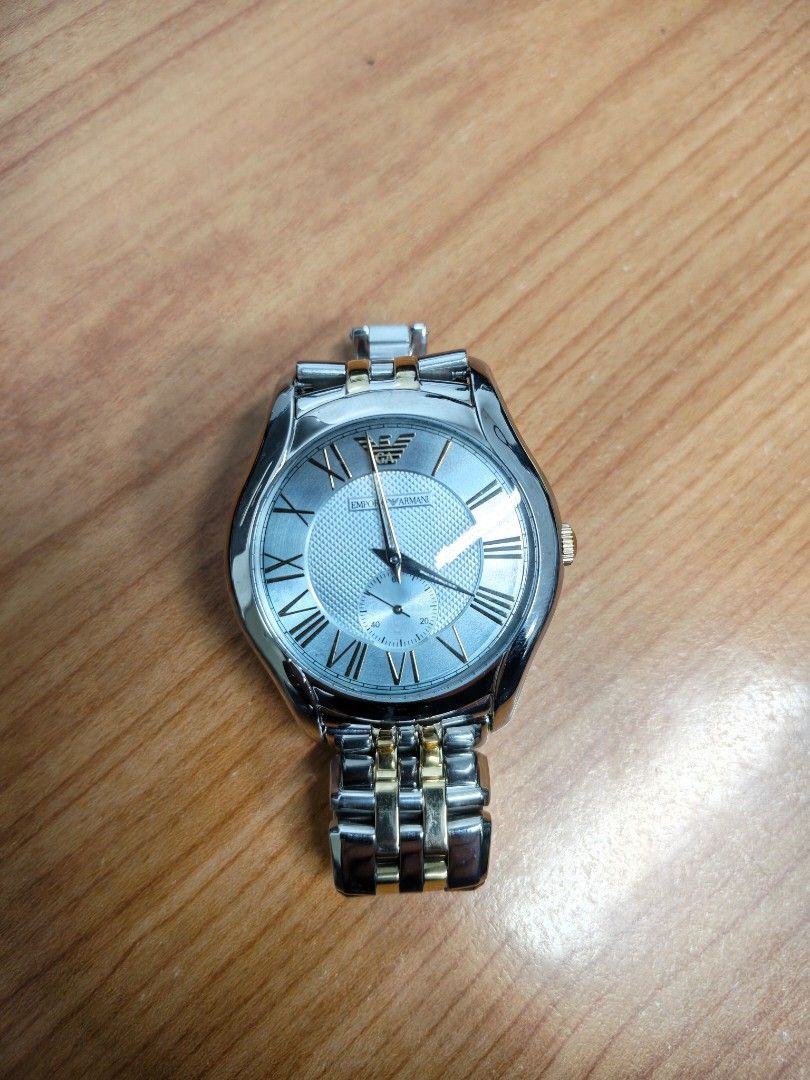 Emporio Armani AR-1044 (Category: Women's Watches) located in Paranaque City. Submitted by hungrypolarbear (Listing ID 1468282135, Image 1). Description: - Brand: Emporio Armani wrist watch AR-1044 - Color: Elegant silver and gold tone finish - Dial: Textured background with classic Roman numeral hour markers and small second sub-dial at the lower right - Strap: Metal link bracelet with alternating silver and gold links - Condition/Details: Clean