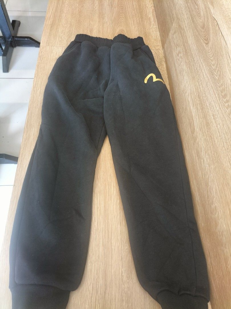 Evisu Heritage Black Sweatpants Size 140 (Category: Joggers) located in Manila. Submitted by patriciab12636 (Listing ID 1468227478, Image 3). Description: - fir kids size 24 lenth 30inches Brand: Evisu Heritage - Color: Black with gold and white graphics - Size: Tagged size 140 - Design: Striking leg prints with small gold gull logo near the hip - Fit: Elastic waistband and ribbed ankle cuffs - Condition: Clean fabric with bright, un-faded graphi